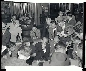 Joseph P. Kennedy Sitting Surrounded by Reporters