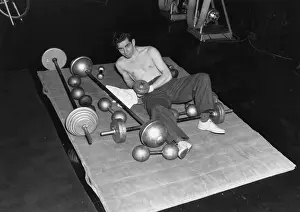 Gymnasium Prints: Joseph Shuster Lying on Mat with Barbells
