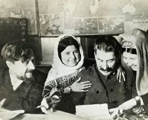 Autographing Prints: Joseph Stalin Reviewing Papers