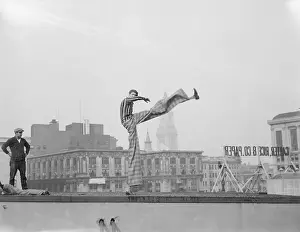 Stunt Prints: Joseph De Vigilio on Stilts on Rooftop