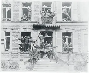 Jubilant Soldiers in Windows and on Balcony of Building
