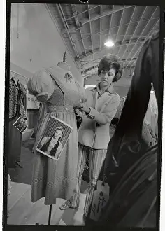 Judy Carroll Putting Tag on A Dress