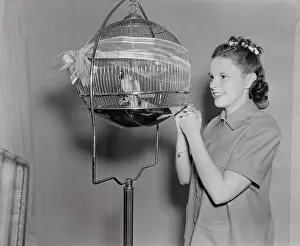 Judy Garland Examining Birds in Cage