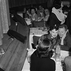 Judy Garland and Mickey Rooney Sitting at Table