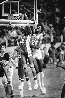 Julius Erving Grabbing Onto Basket After Dunk