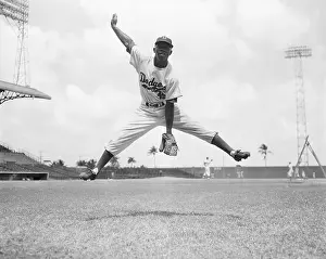 Junior Gilliam Jumping With His Legs Spread