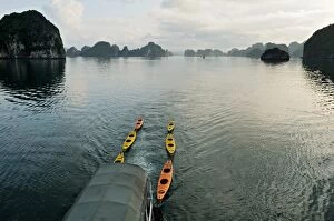 Images Dated 8th May 2013: Kayaks pulled by a boat in Bai Tu Long - Ha Long bay - Vietnam