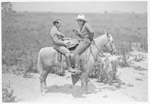 Ken Maynard and Al Rogell Playing Checkers Atop Horse