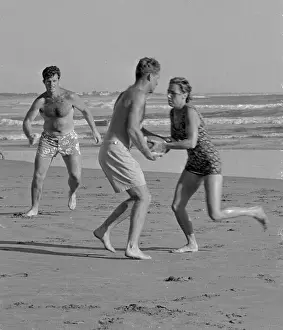 Kennedys Playing Football on Beach