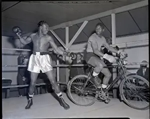 Welterweight Prints: Kid Gavilan In Ring with Man On Bicycle