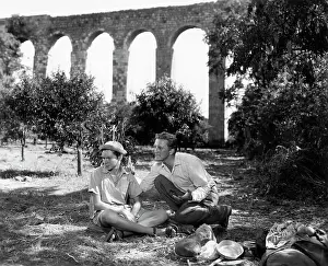 Kirk Douglas and Joey Walsh Sitting on Ground in Scene from The Juggler