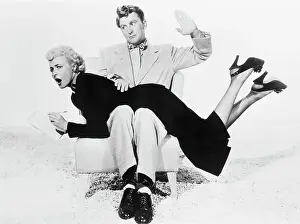 Kirk Douglas with Laraine Day over His Knee