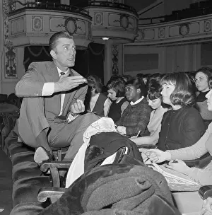 Kirk Douglas Sits on Desk Talks to Students
