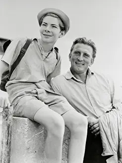 Kirk Douglas Standing by Joey Walsh on a Fence
