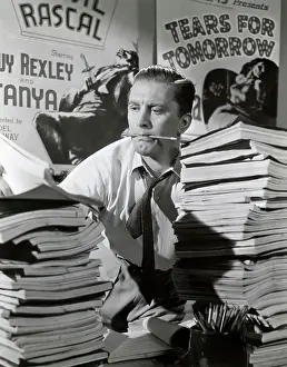 Script Prints: Kirk Douglas Struggles Piles Of Scripts