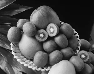 Tray Prints: Kiwi fruits and mangos on tray against black background