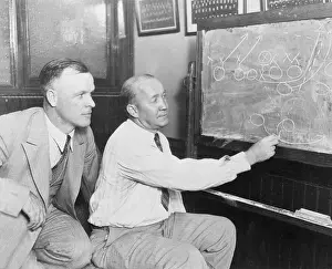 Knute Rockne Going over Plays on Blackboard