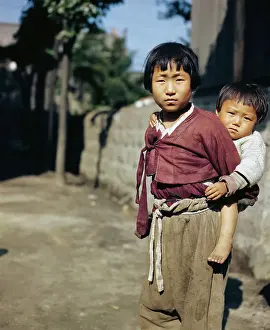 Korean Child Carrying Baby on her Back
