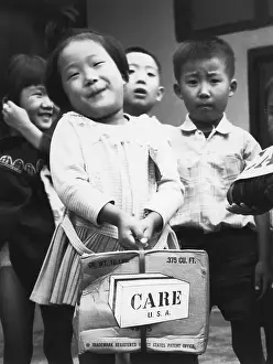 Korean Girl with Care Package Smiling