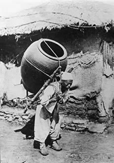 Prints of A street vendor carries a large clay vessel containing prepared food for sale on his back, Korea, early 20th Century. (Photo by Frederic Lewis/Getty Images) Urban Echoes of America’s Golden Age: Korean street vendor