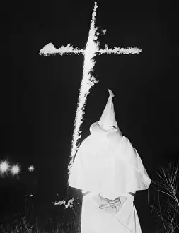 Ku Klux Klansman Looking at Burning Cross