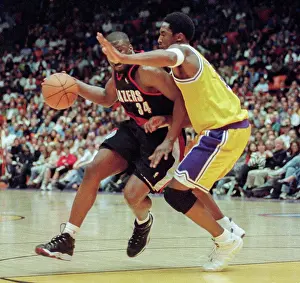 Prints of Los Angeles Lakers Kobe Bryant (R) defends against Trailblazers Isaiah Rider during Game 2 action during the NBA Playoff game against Portland Trailblazers, April 26, 1998 in Inglewood, California Courtside Vibes: Stunning Basketball Prints: LA Lakers Kobe Bryant Playoff Game 2
