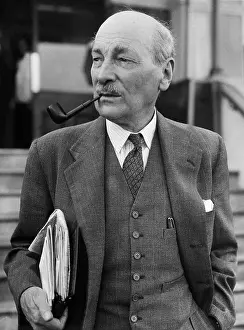 Prints of (Original Caption) 10/15/1955-Margate, Kent, England: Pipe in mouth and with an arm full of papers A Quiet Strength: A Leader Who Shaped Modern Britain: Labor Party Leader Atlee W/ Papers, Pipe