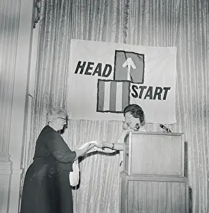 Lady Bird Johnson beneath Sign