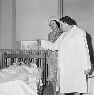 Lady Bird Johnson Speaking to a Bedridden Man