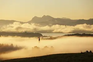 Morning Fog Prints: Lake Chiemsee and the church steeple of Greimharting as seen from Ratzinger Hoehe in the early morning