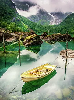 Prints of A bright yellow boat contrasts on the green Lake Bondhus located in Foglefanna National Park, Norway. Bondhusbreen glacier can be seen in the background Travel Imagery Prints: Lake of Dreams