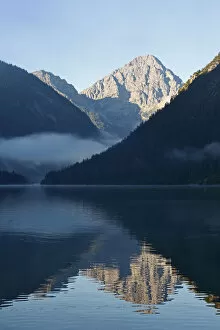 Mirrored Gallery: Lake Plansee and Ammergebirge mountains, in the back Mt. Thaneller in the Lechtal Alps, Tyrol