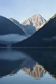 Reflected Gallery: Lake Plansee and Ammergebirge mountains, in the back Mt. Thaneller in the Lechtal Alps, Tyrol