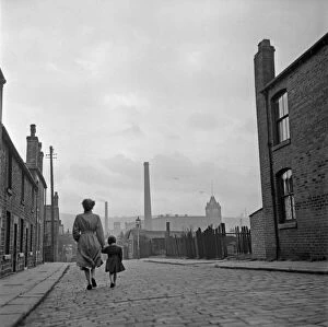 Lancashire Gallery: Lancashire Mill Town; Cotton mill worker Alice Nelson sets out for work at the Lilac Mill in Shaw