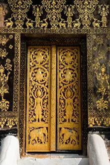 Images Dated 6th August 2016: The Laotian golden gilded black lacquer art technique and wood carving at the door inside
