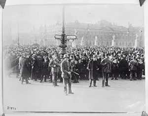 Large Crowd Standing Behind Street Sign