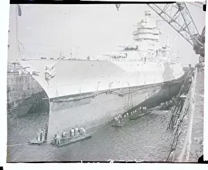 Large Ship Being Worked on by Crew
