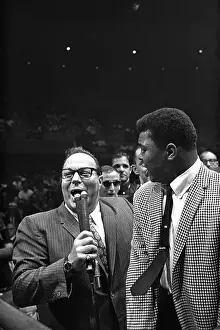 LAS VEGAS, NV - JULY 22: Heavyweight contender Cassius Clay (later known as Muhammad Ali) attempts to get to the ring to taunt Sonny Liston who has just defeated former champion Floyd Patterson to retain his heavyweight crown) on July 22
