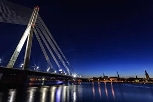 Images Dated 29th September 2014: Latvia, Riga, River Daugava, Illuminated Vansu Bridge reflecting in river