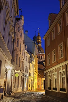 Images Dated 30th September 2014: Latvia, Riga, View of illuminated street in old town and Riga Cathedral at dusk