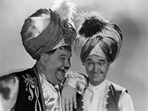 Prints of 1942: Oliver Hardy (1892 - 1957) the ample American comedian, with Stan Laurel (1890 - 1965), his British born sidekick, wearing turbans as they appear in A Haunting We Will Go' Timeless Comedy Icons: Classic Moments from the Legendary Duo: Laurel And Hardy