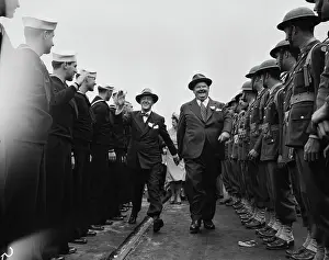 Prints of Comedy duo Stan Laurel (1890 - 1965) (center left) and Oliver Hardy (1892 - 1957) (center right) laugh and smiles as they walk along a line of soldiers and sailors, late 1930s or early 1940s Timeless Comedy Icons: Classic Moments from the Legendary Duo: Laurel And Hardy & The Military