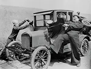 Prints of (Original Caption). Stan Laurel and Oliver Hardy as sailors, puling the fenders off a Model T Ford while worried driver looks on. Movie still, 1928 Timeless Comedy Icons: Classic Moments from the Legendary Duo: Laurel and Hardy in Movie Still