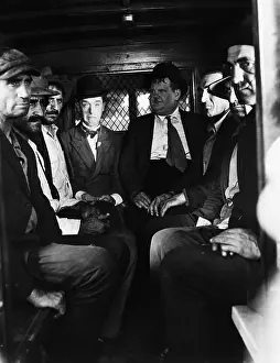 Prints of (Original Caption). Undated film still featuring comedeians Stan Laurel (1890-1965) and Oliver Hardy (1892-1957) Timeless Comedy Icons: Classic Moments from the Legendary Duo: Laurel & Hardy Seated In Paddy Wagon