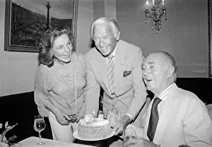 Lauren Bacall Presenting a Cake to Brian Aherne