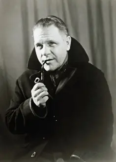 Lawrence Durrell Smoking a Pipe
