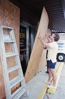 Protecting Prints: Leland Waiet and Dad Put Boards On Door
