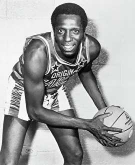 Prints of Photograph of Lemon Meadowlark of the Harlem Globetrotters. Photo shows Meadowlark with basketball in an action pose in front of a brick wall. Undated Photograph Hoops Through Time: A Visual Journey of Basketball History: Lemon Meadowlark