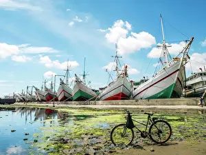 Full length of the Phinisi Ships docking at Sunda Kelapa Harbor in the morning