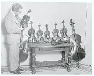 Leopold Stokowski Inspecting Rare Violins